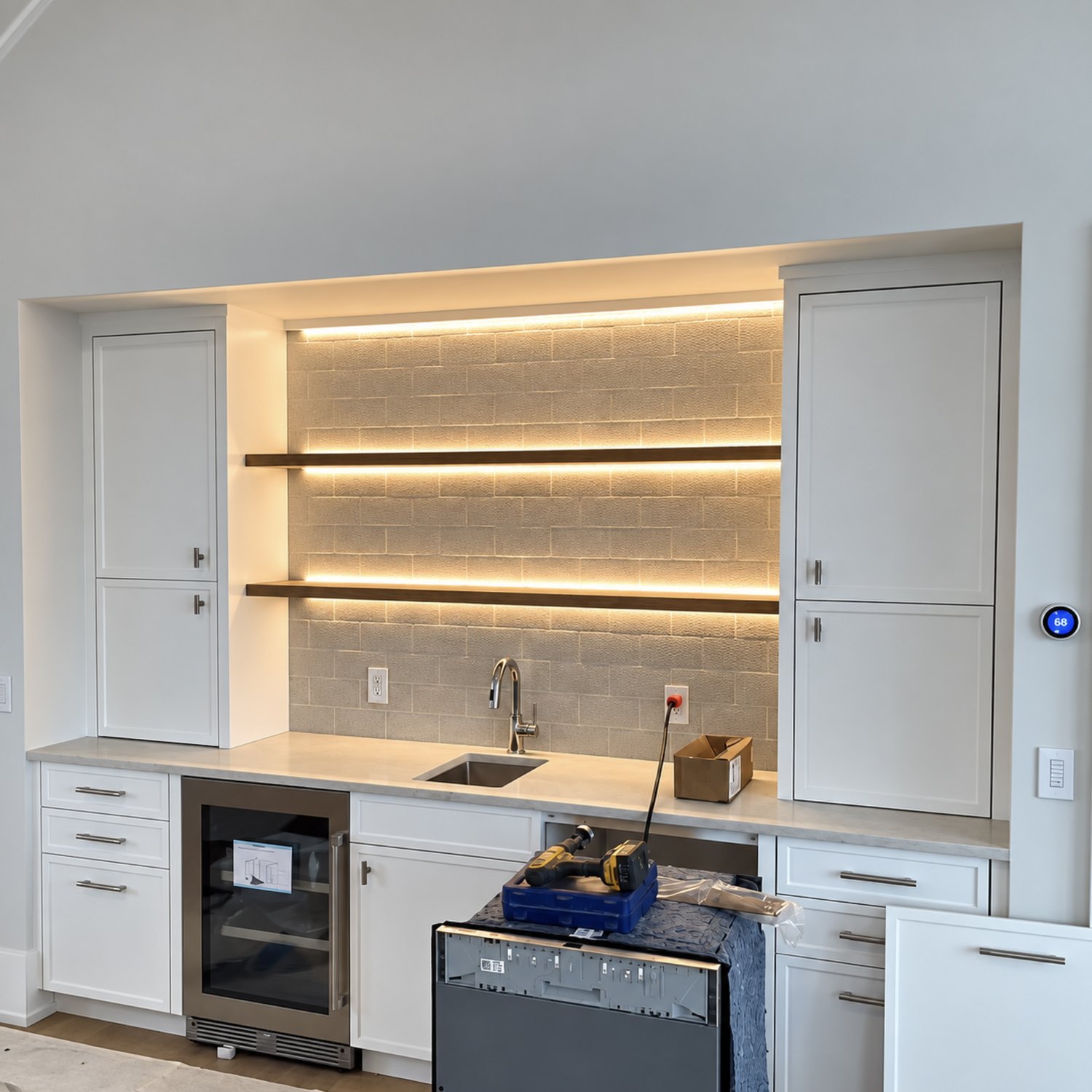 Wet bar with backlit floating shelves and a beverage fridge