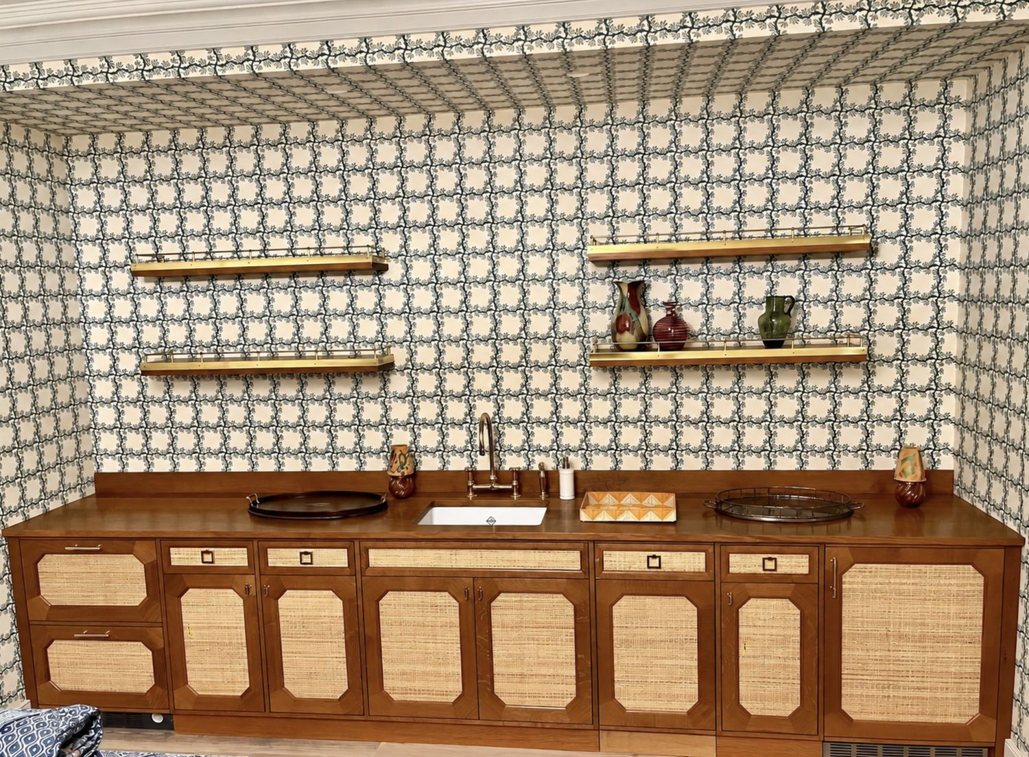 Walnut kitchen cabinetry with caned door panels and open shelving
