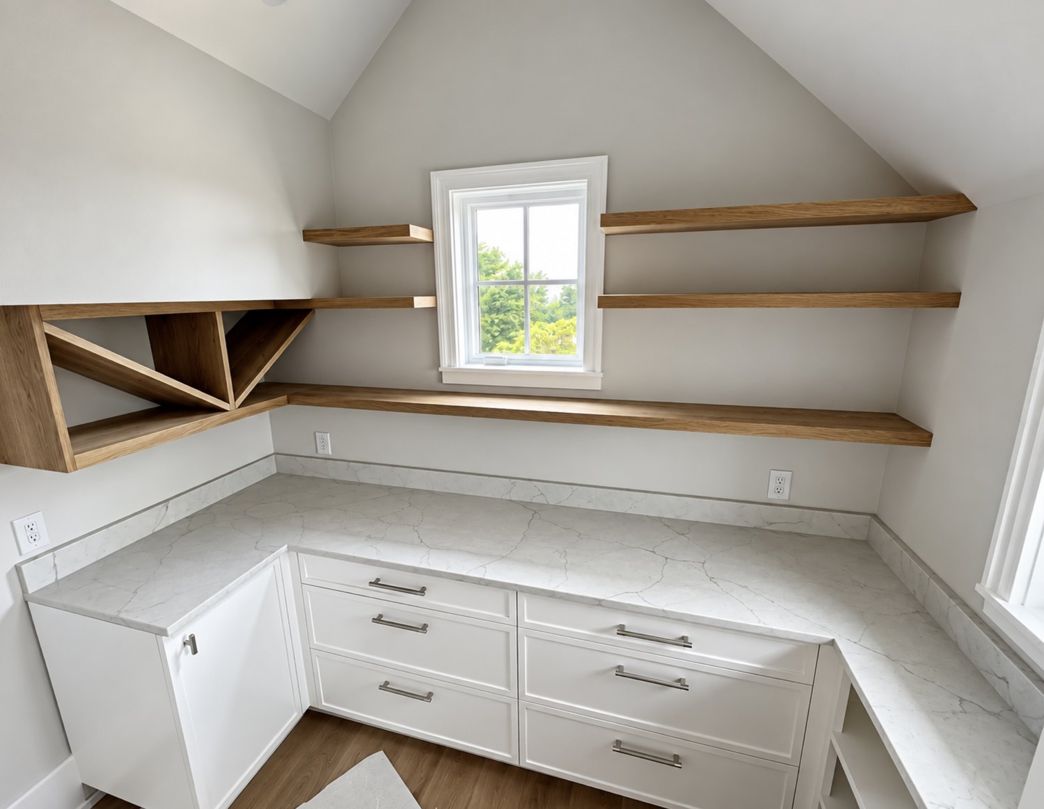 Home office with white cabinets and floating white oak shelves