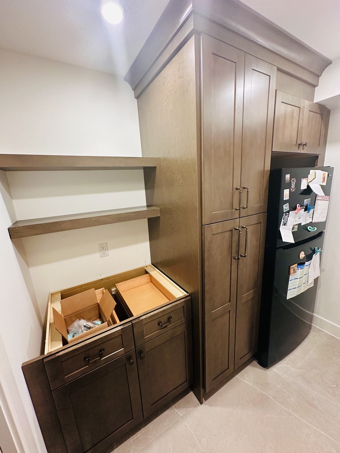 Stained pantry cabinets and a built-in refrigerator surround