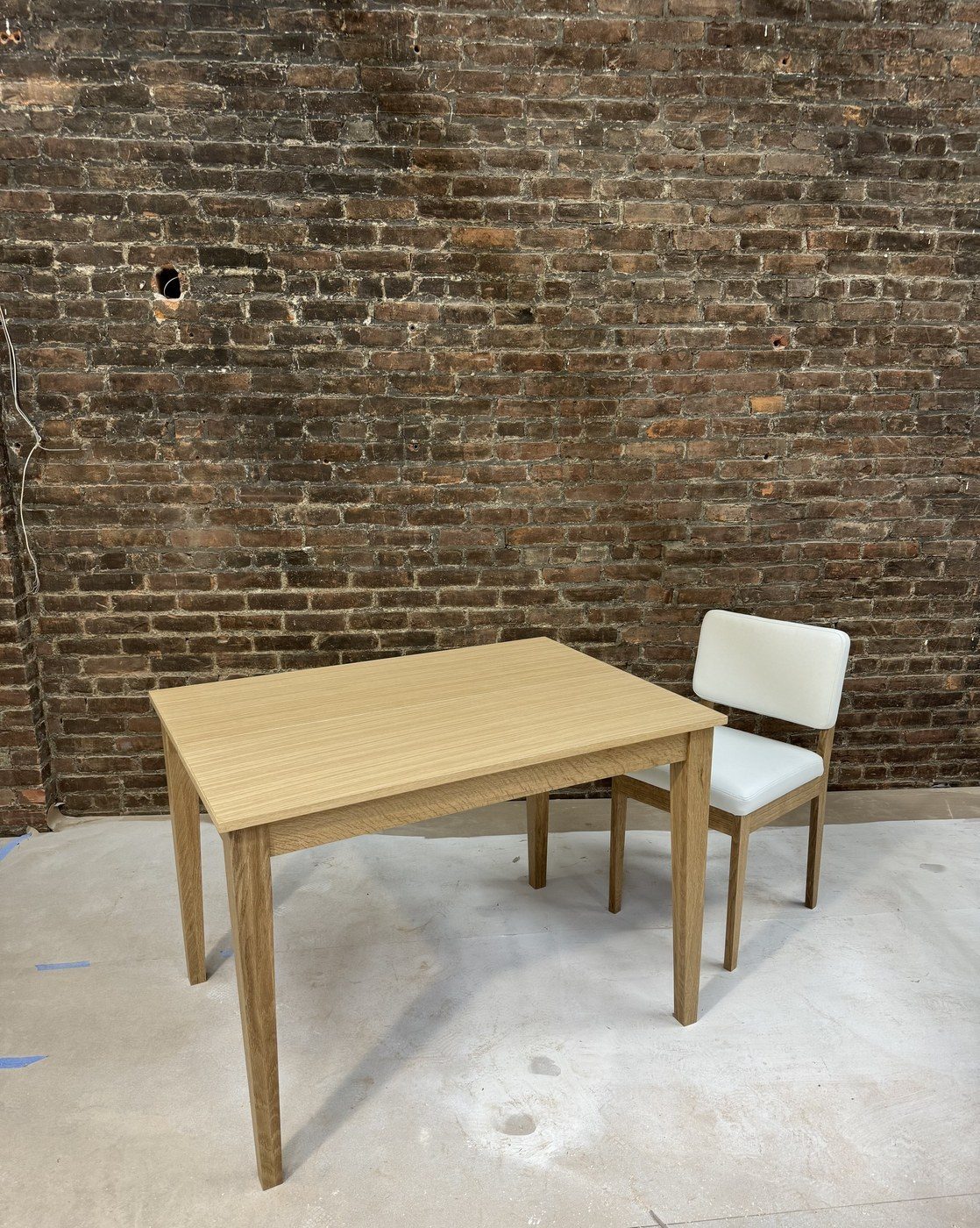 Oak table and chair seen from the end