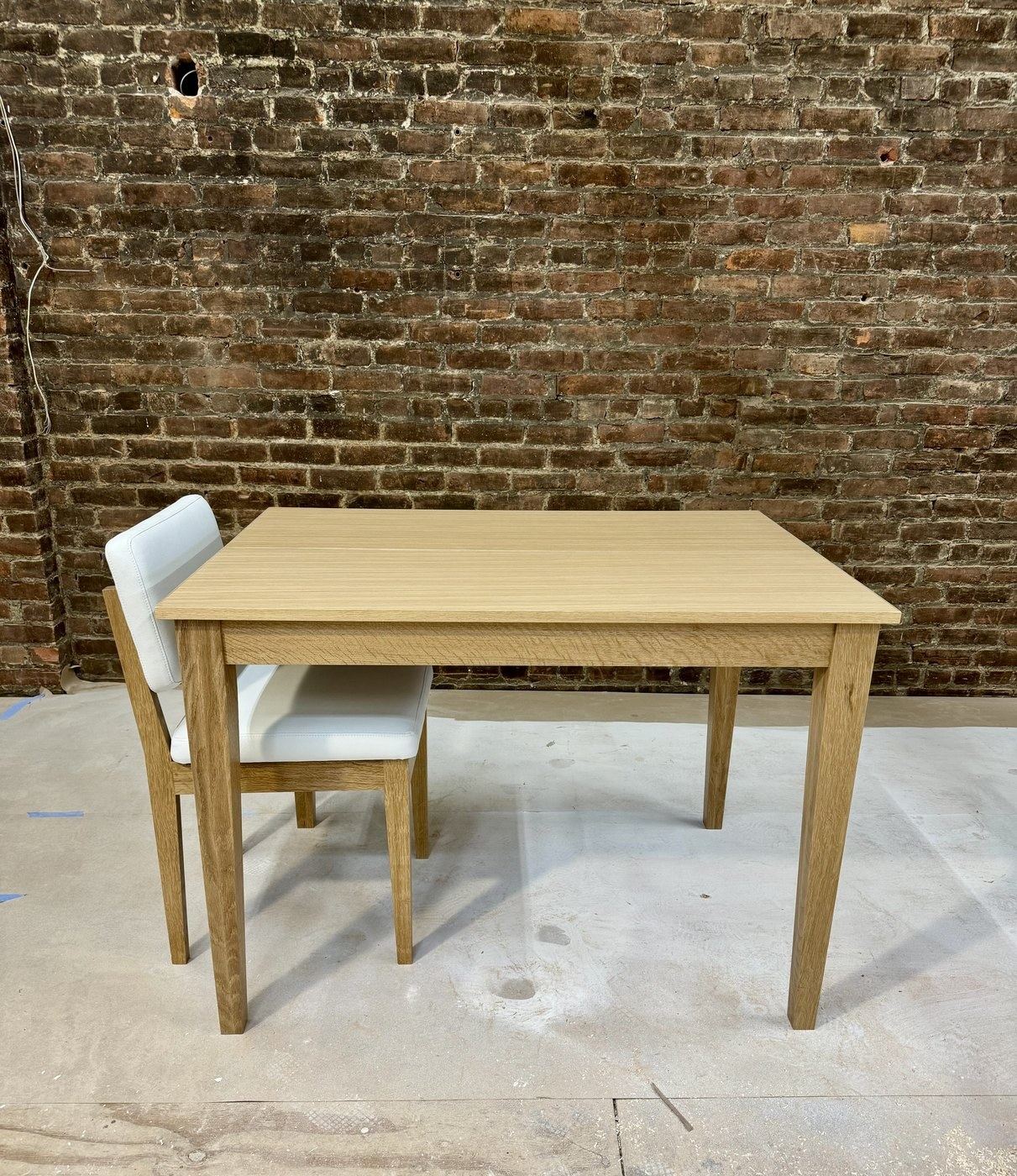 Oak dining table with a matching upholstered chair