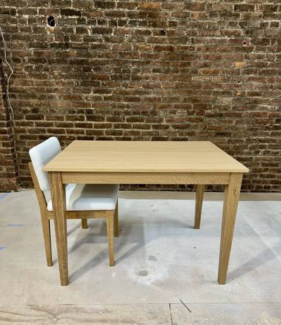 Oak dining table with a matching upholstered chair