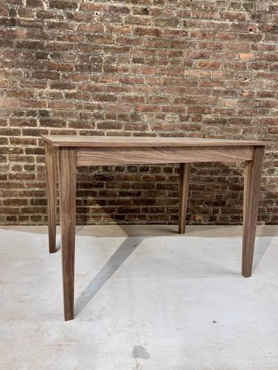 Walnut dining table with tapered legs